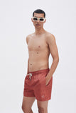 Terracotta Swim Shorts with 'Leone' print, a stylish collaboration by Uberta Zambeletti.