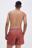 Terracotta Swim Shorts with 'Leone' print, a stylish collaboration by Uberta Zambeletti.