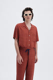 Terracotta Iconic Pants with 'Leone' print, a stylish collaboration by Uberta Zambeletti.